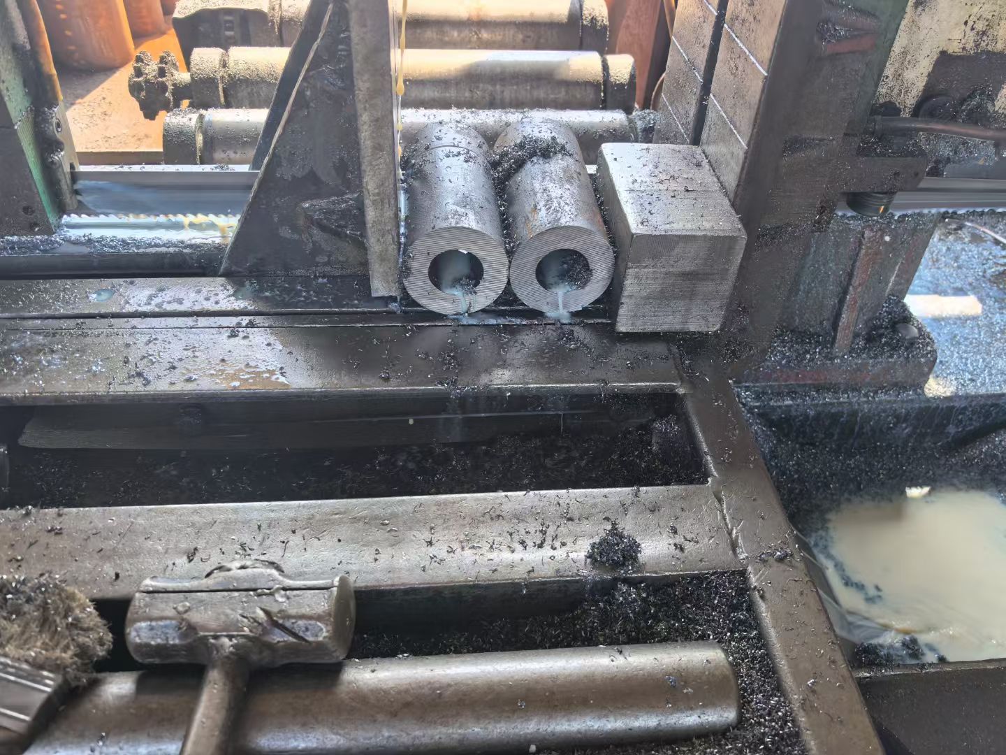 Close-up of a band saw blade correctly tensioned on the wheel and through the guides