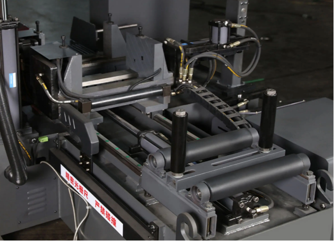 band saw blade guides a close-up of band saw blade guides positioned near a metal workpiece